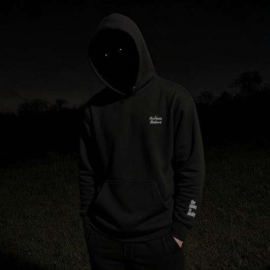 The Moon Is Awake hoodie - front view with chest embroidery worn at night